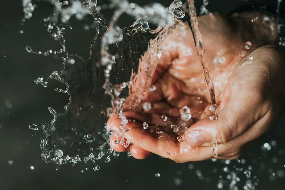 Hands cupping running water, a quiet moment of everyday care